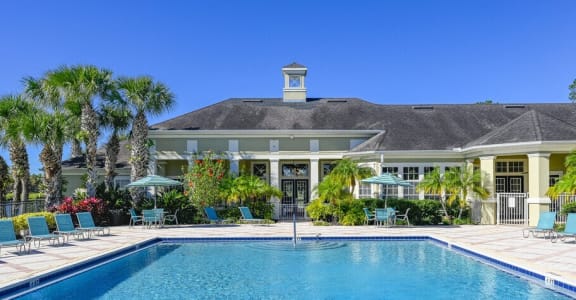 a large swimming pool in front of a house