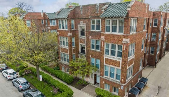 an aerial view of a brick apartment building with a parking lot at The Bryant at Oak Park I & II, Oak Park