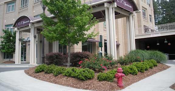 A large building with a red fire hydrant in front of it.