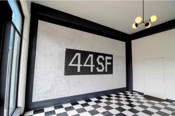 a tile mural on the wall in the corner of a room at Metro67, Memphis