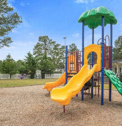 a playground with a swing set and slides