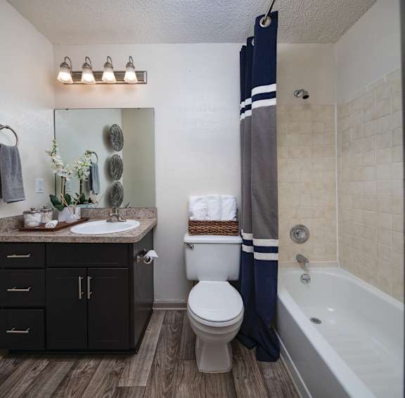 A bathroom with a toilet, sink, and bathtub.