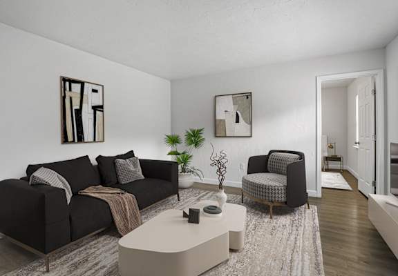 a living room with two black couches and a white coffee table