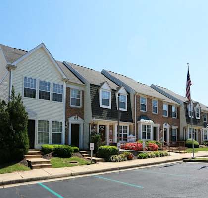 a row of town homes on a street with a flag, main office