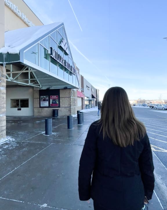 a woman walking in front of a building at Boulder Ridge, Duluth Minnesota