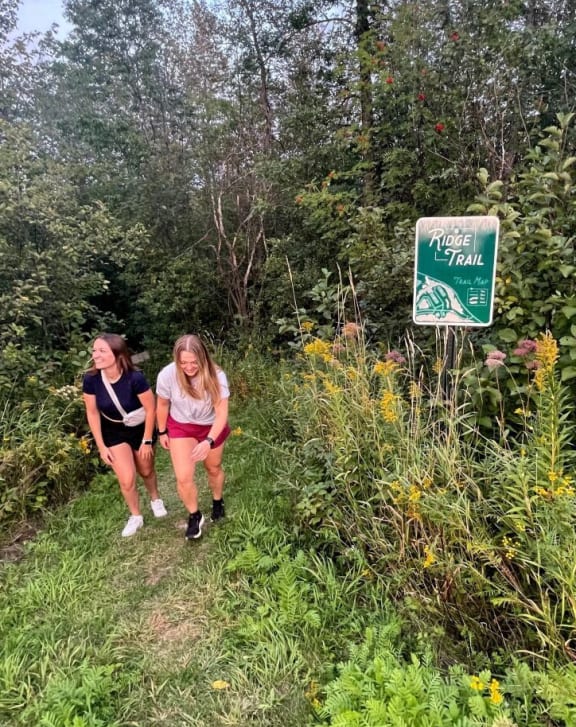 two women walking on a trail in the woods at Boulder Ridge, Duluth Minnesota