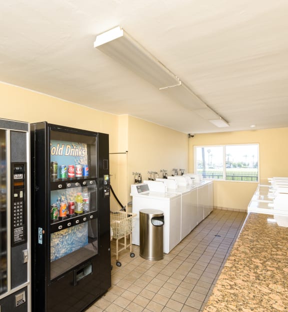 a snack room with two vending machines and a counter