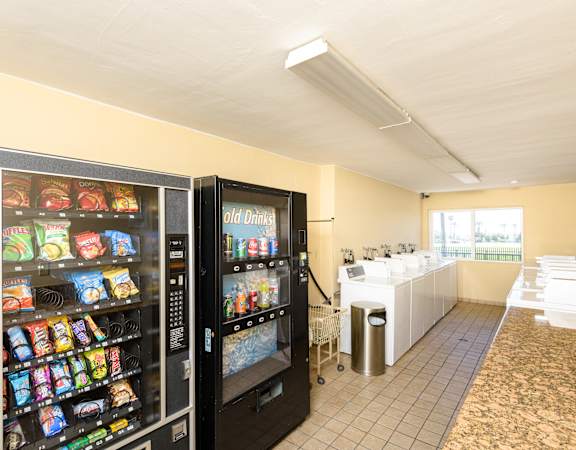 a snack room with two vending machines and a counter