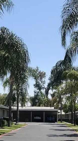 A row of houses with a sign that says "Welcome Home" in front of them.