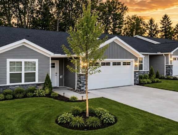 A house with a grey exterior and a white garage door.