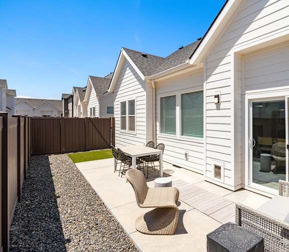 A white house with a patio furniture set.at Alante Homes at Spring Run, Idaho