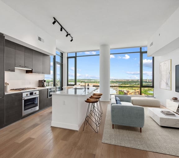 an open kitchen and living room with a view of the city at The Grace and Reva, Arlington