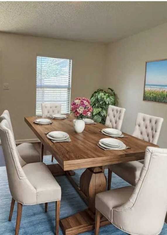 A dining room with a wooden table and chairs.