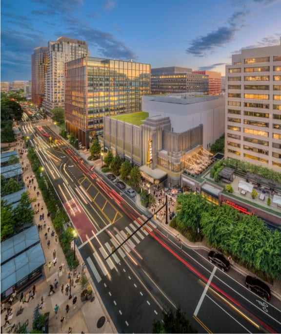 an aerial view of a city street with traffic and tall buildings