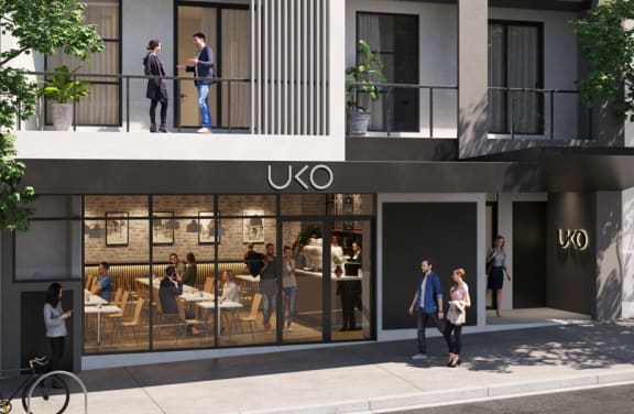 a rendering of the uxo building facade with people walking outside
