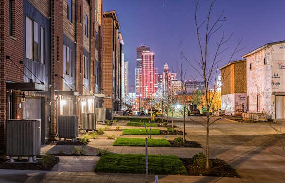 a view of the city skyline at night from a street at 5Fifty5, Iowa, 50309