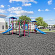 A playground with a blue slide and wooden structure.