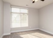 Thumbnail 34 of 48 - an empty room with a window and a ceiling fan