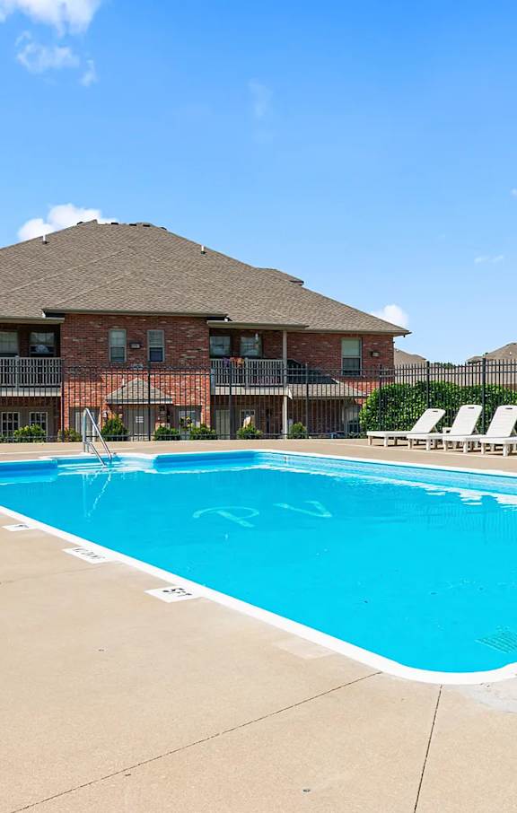 A large swimming pool in front of a building.