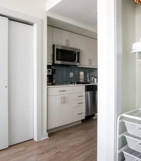 a kitchen with a refrigerator freezer next to a stove top oven