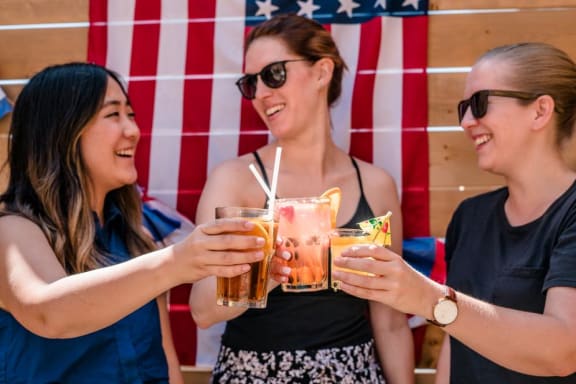 Friends with drinks on July 4th party at Mirabella Apartments, Bermuda Dunes, California