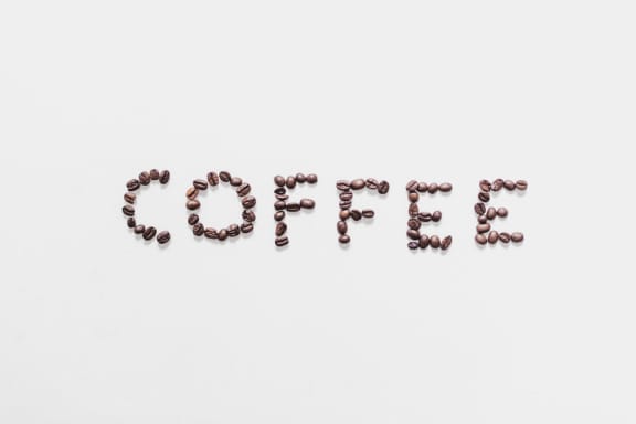 Coffee beans spelling the word on light background at Mirabella Apartments, Bermuda Dunes, CA