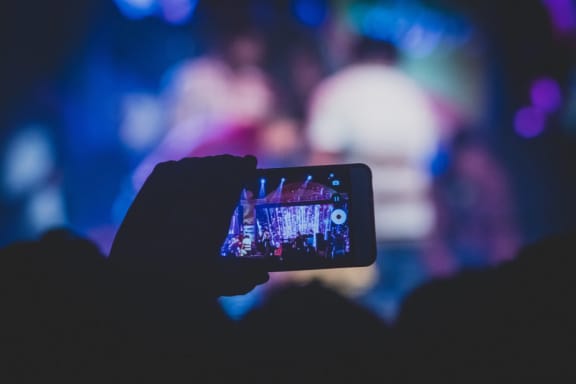 Fan recording concert on phone at Mirabella Apartments, Bermuda Dunes, California