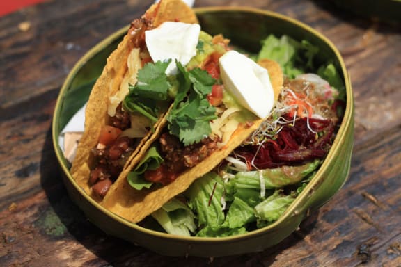 Tacos plated over salad in a green bowl at Mirabella Apartments, 40300 Washington St, Bermuda Dunes