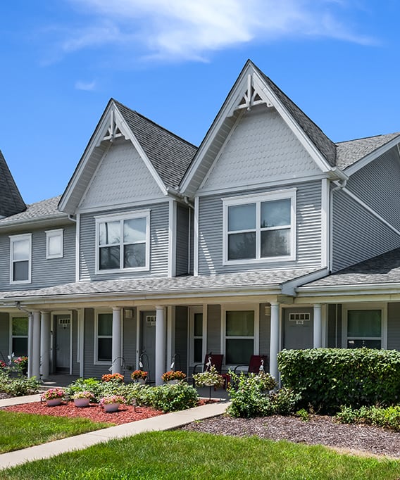 a row of townhouses on the side of a street