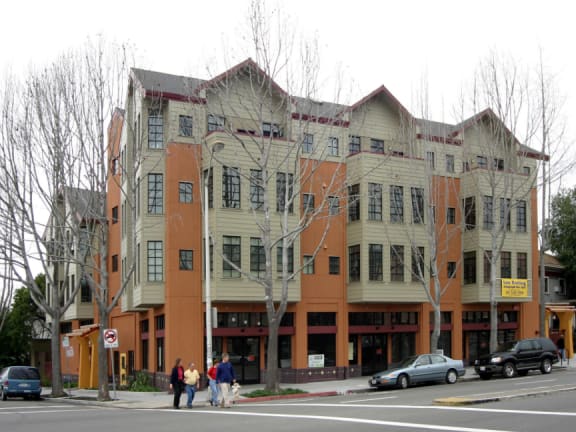 an apartment building on the corner of a city street