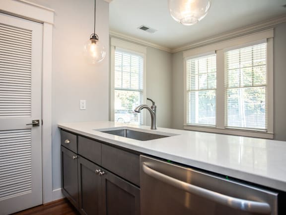 A kitchen with a sink and a window.