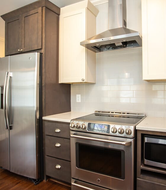 A modern kitchen with stainless steel appliances and wooden cabinets.