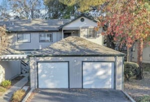 a house with two garage doors in front of it
