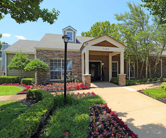 A building with the number 7149 on it is surrounded by a garden.