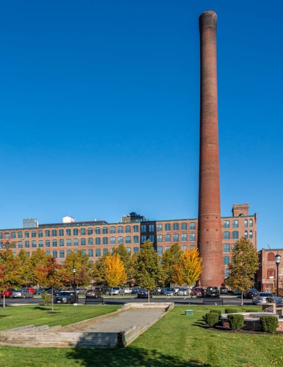 a large brick building with a fountain in front of it