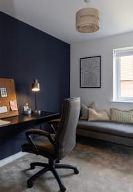 a home office with a desk and a couch