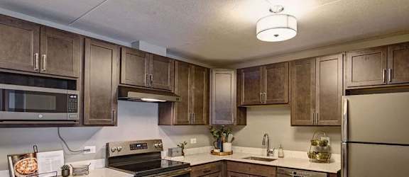 a kitchen with stainless steel appliances and wooden cabinets