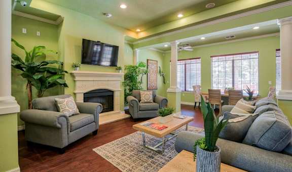 a living room with green walls and a fireplace