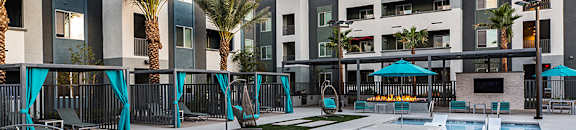 Pool view with seating and lounge chairs at ARISTA APARTMENT HOMES, Nevada