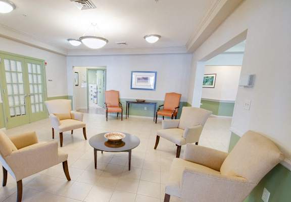 a waiting room at a hospital with chairs and a table