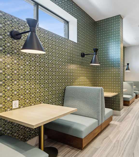 A restaurant with booths and tables.