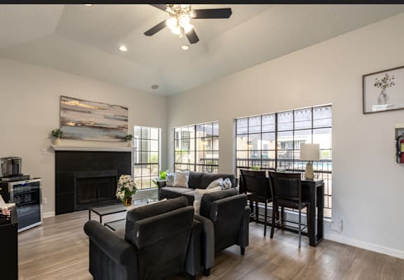 A living room with a fireplace and a ceiling fan.