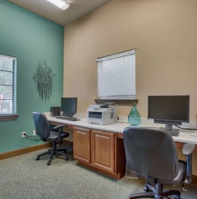 office room with chairs and window and computers
