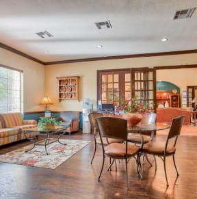 a living room and dining room with a table and chairs