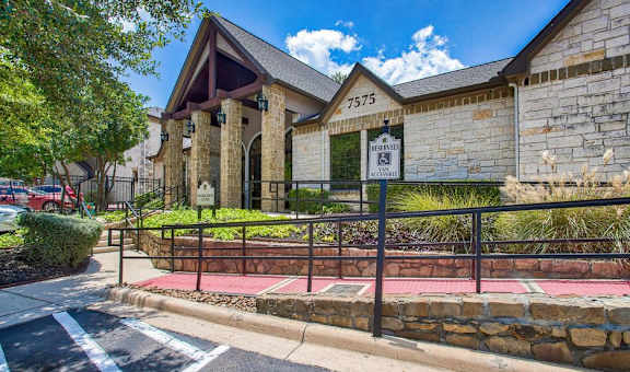the front of a building with a fence in front of it