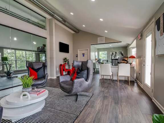 a living room with white couches and a coffee table