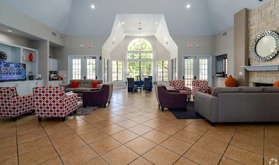 A spacious living room with a large window and a fireplace.