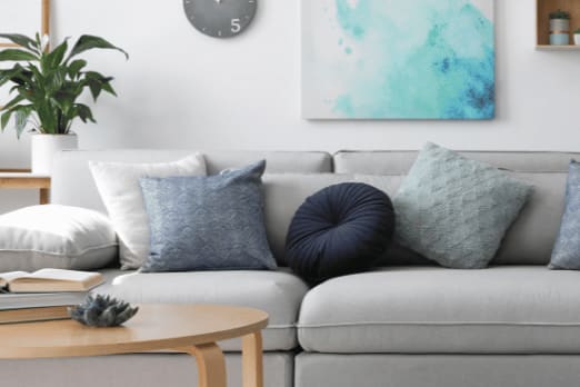 a living room with a couch and pillows