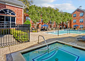 Thumbnail 12 of 50 - Luxury apartments with large swimming pool, spa, and large sundeck with poolside lounge chairs at The Lanesborough Apartments in Houston.