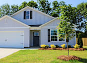 Thumbnail 1 of 6 - a white house with a garage door and a lawn